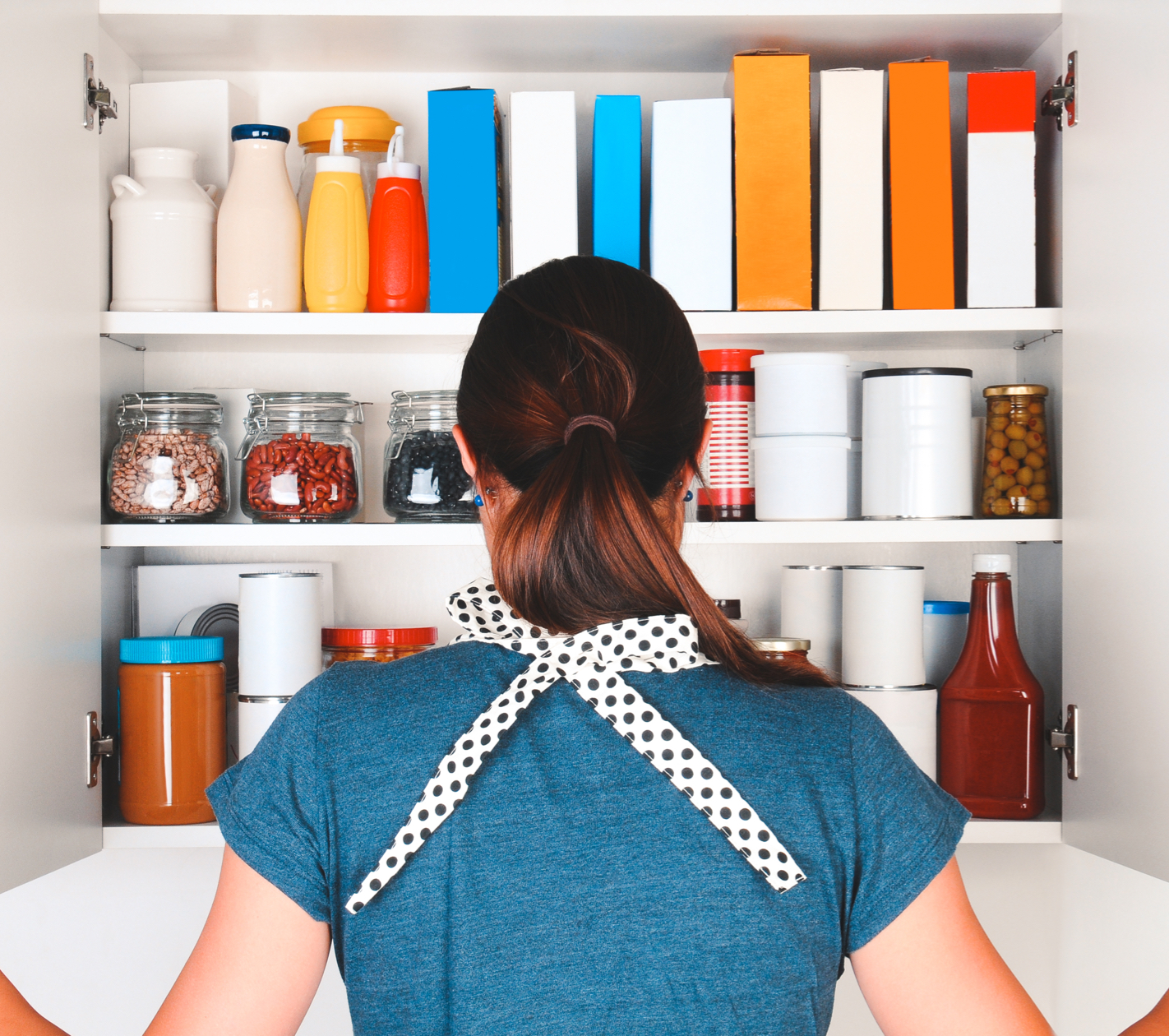 woman looking into pantry